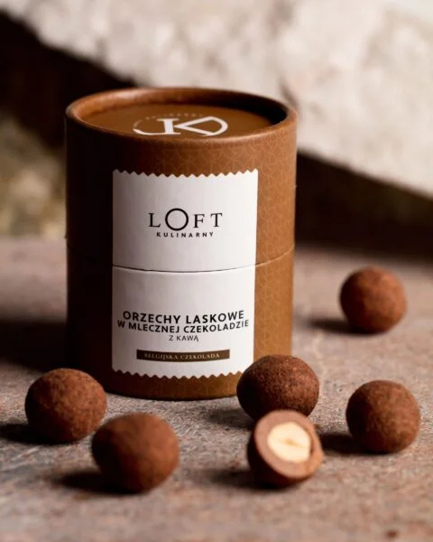 orzechy laskowe w mlecznej czekoladzie z kawą w eleganckim opakowaniu na loftowym tle